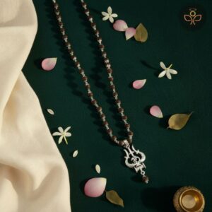 The OM Shiva Trishool Karungali Mala is a powerful spiritual rosary made from natural Karungali (Black Ebony) wood, combined with sacred OM, Shiva, and Trishool symbols. It provides protection from negativity, enhances meditation, and attracts the divine blessings of Lord Shiva.