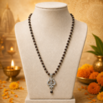 The OM Shiva Trishool Karungali Mala is a powerful spiritual rosary made from natural Karungali (Black Ebony) wood, combined with sacred OM, Shiva, and Trishool symbols. It provides protection from negativity, enhances meditation, and attracts the divine blessings of Lord Shiva.